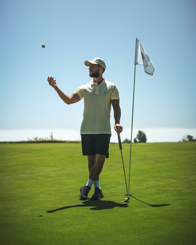 male golfer tossing a ball