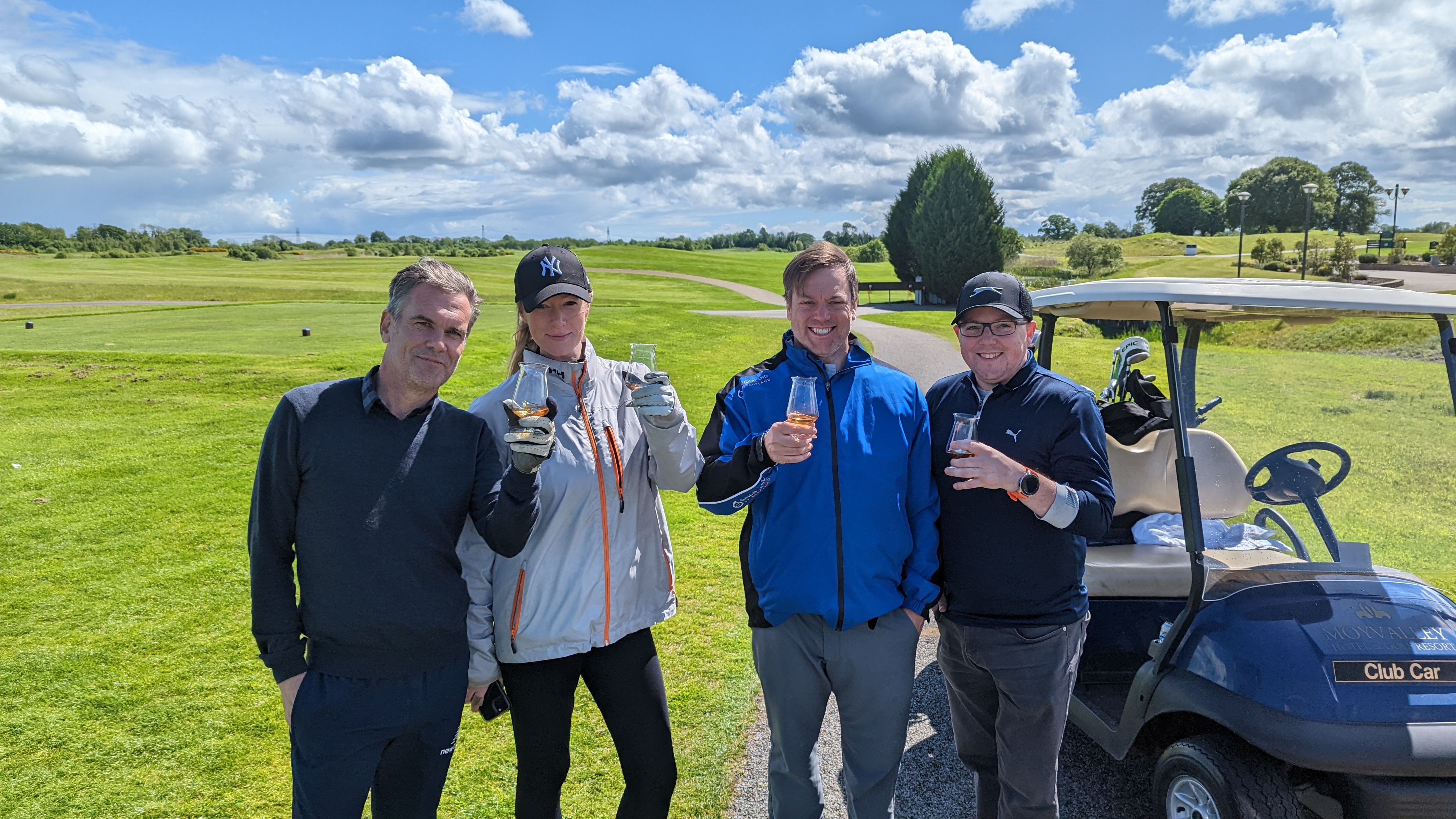 group-picture of golfers holding a glass